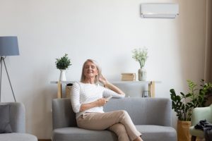 woman-sits-in-living-room-with-mini-split